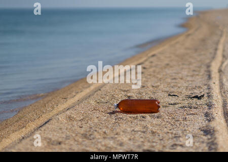 Empty plastic bottle lies on the seashore Stock Photo