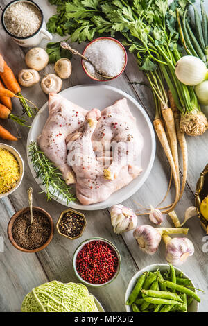 Raw chicken legs with assortment spices and vegetables. Stock Photo