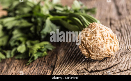 Fresh celery root with leaf on rustic oak table. Stock Photo