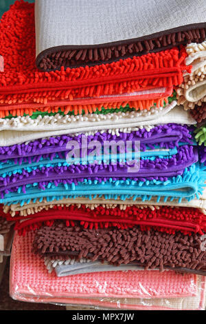 Pile of colorful bathroom rugs and floor mats Stock Photo