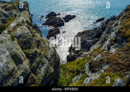 Steep Rocky Descent to sea and beach below at Porth Dafarch, Anglesey, North Wales, UK Stock Photo