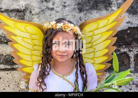 Cuidad Vieja,, Guatemala -  December 7, 2017: Girl dressed as angel in parade celebrating Our Lady of the Immaculate Conception Day near Antigua. Stock Photo