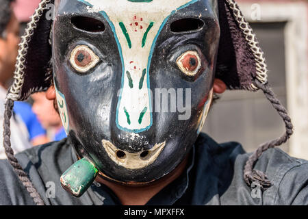 Cuidad Vieja,, Guatemala -  December 7, 2017: Local in traditional folk dance mask in parade celebrating Our Lady of the Immaculate Conception Day. Stock Photo