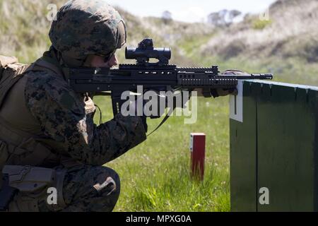 U.S. Marine Corps Sgt. Randel McCellean, combat marksmanship instructor, Marksmanship Training Company, Weapons Training Battalion, conduct shooting drills with a SA80 A2 assault rifle during the Royal Marine Operational Shooting Competiton (RMOSC) at Altcar Training Camp, Hightown, United Kingdom, May 15, 2018, May 15, 2018. The U.S. Marine Corps travels to the United Kingdom annually to compete in the (RMOSC) with the opportunity to exchange operational experiences, physical and marksmanship training. (U.S. Marine Corps photo by Cpl. Robert Gonzales). () Stock Photo