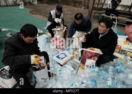 Members of the North Korean Refugees Human Rights Association of Korea (NKR) filling rice in plastic bottles with a written message which reads 'God loves you' to be send to North Korea from South Korea's Ganghwa Island in hope that they would be picked up by North Koreans and help change the attitude that North Koreans have towards people in the South. Stock Photo