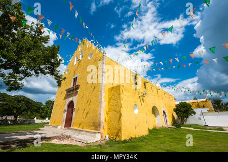 Low angle view of buntings hanging on church against blue sky during sunny day Stock Photo