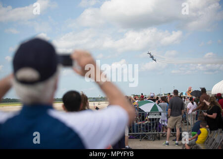 BELLE CHASSE, La. – Spectators at the 2017 New Orleans Air Show watches the Blue Angels perform aerial acrobatics during the New Orleans Air Show 2017 at Naval Air Station Joint Service Base New Orleans, April 21, 2017.  The show included several demonstration teams, Air Show Announcer Rob Reider, and parachute teams.  (U.S. Marine Corps photo by Pfc. Niles Lee) Stock Photo