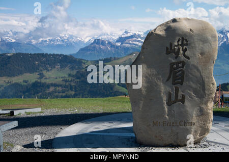 Boulder taken from Mt Emei at the top of its sister mountain of rigi with mountains in the background Stock Photo