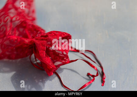 Red drawstring bag On a gray-blue background Stock Photo