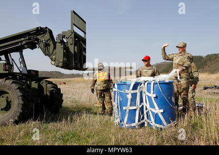 Soldiers from 25th Transportation Battalion, 19th Expeditionary Sustainment Command and 2nd Infantry Division Sustainment Brigade work to recover 55-gallong drums, April 12, 2017, at a drop zone between Daegu and Busan, South Korea. Multiple U.S. assets and ROK Air Force validated their aerial logistics capabilities as part of ongoing exercise Operation Pacific Reach ’17. Stock Photo