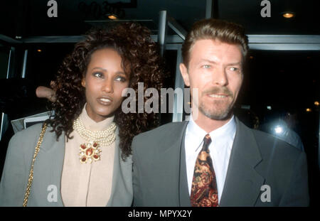 BEVERLY HILLS, CA - MARCH 5: (L-R) Model Iman and singer/musician David Bowie attend the premiere of 'La Femme Nikita' on March 5, 1991 at the Music Hall Theater in Beverly Hills, California. Photo by Barry King/Alamy Stock Photo Stock Photo