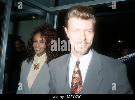 BEVERLY HILLS, CA - MARCH 5: (L-R) Model Iman and singer/musician David Bowie attend the premiere of 'La Femme Nikita' on March 5, 1991 at the Music Hall Theater in Beverly Hills, California. Photo by Barry King/Alamy Stock Photo Stock Photo