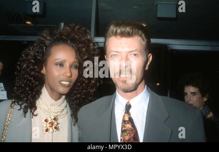 BEVERLY HILLS, CA - MARCH 5: (L-R) Model Iman and singer/musician David Bowie attend the premiere of 'La Femme Nikita' on March 5, 1991 at the Music Hall Theater in Beverly Hills, California. Photo by Barry King/Alamy Stock Photo Stock Photo