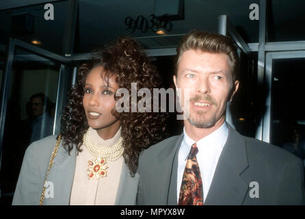 BEVERLY HILLS, CA - MARCH 5: (L-R) Model Iman and singer/musician David Bowie attend the premiere of 'La Femme Nikita' on March 5, 1991 at the Music Hall Theater in Beverly Hills, California. Photo by Barry King/Alamy Stock Photo Stock Photo