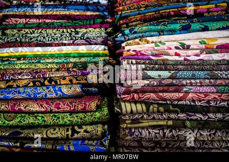 Two colorful stacks of sarongs seen at the morning market in Ubud, Bali; Indonesia (10.05.2018) Stock Photo