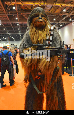 A cosplay enthusiast dressed up as the Wookiee, Chewbacca ('Chewie') a fictional character in the Star Wars franchise on the opening day of MCM London Comic Con at the ExCel Centre in East London, UK.  Tens of thousands of cosplay enthusiasts  attended the show and more than 130,000 are expected to walk through the doors by the end of the three-day event which finishes on Sunday. Credit: Michael Preston/Alamy Live News Stock Photo