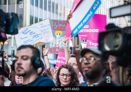 Planned Parenthood supporters with signs  at a Planned Parenthood supporters with signs  at a Title X (Title Ten) gag rule rally in New York City, hosted by Planned Parenthood of New York City on May 24th 2018, reacting the President Trump's attempt to ban Medicaid and federal funding to medical providers who provide full, legal medical information to patients wanting or needing abortion services. Stock Photo
