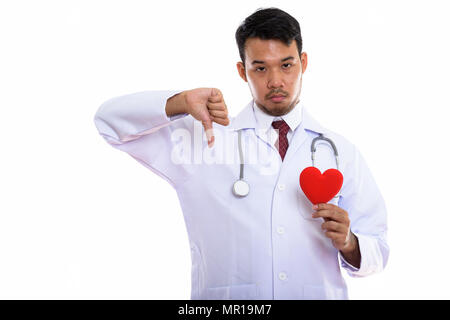 Studio shot of young Asian man doctor holding red heart and givi Stock Photo