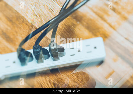 electrical plugs connected to a power strip Stock Photo