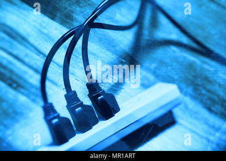 electrical plugs connected to a power strip Stock Photo