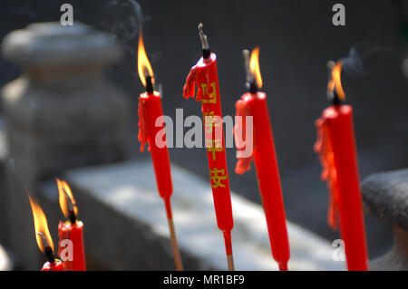 Red candles burning in the temple A-Ma in Macao, China. Stock Photo