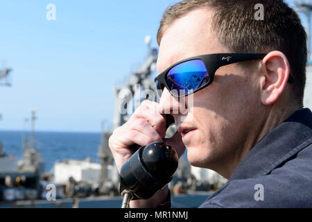 SEA OF JAPAN (April 27, 2017) Lt. Timothy Winters communicates on the  bridge wing of the Arleigh Burke-class guided-missile destroyer USS  Fitzgerald (DDG 62) during a replenishment-at-sea. Fitzgerald is on patrol  in