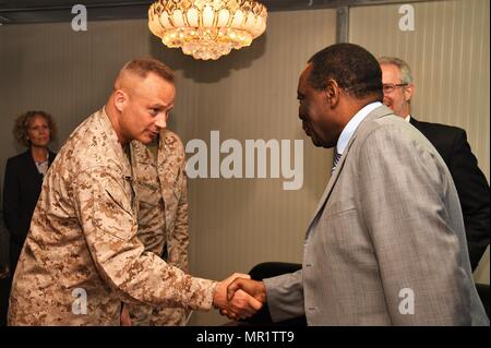 Combined Joint Task Force-Horn of Africa (CJTF-HOA) Commander U.S. Marine Corps Brig. Gen. David J. Furness and the Special Representative of the Chairperson of the African Union Commission for Somalia Ambassador Francisco Caetano Jose Madeira exchange greetings before their meeting at Mogadishu International Airport, Somalia, April 29, 2017. Having assumed command the day prior, the event served as Furness’s first official key leader engagement as the CJTF-HOA commander. (U.S. Air National Guard photo by Tech. Sgt. Andria Allmond) Stock Photo
