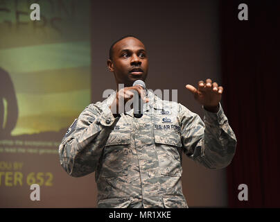 Tech. Sgt. Glenn Davis, 335th Training Squadron personnel apprentice course NCO in charge, welcomes Airmen from the 81st Training Group to the Airmen Building Airmen Symposium at the Welch Theater April 21, 2017, on Keesler Air Force Base, Miss. The Air Force Sergeants Association Chapter 652, sponsored the event designed to inspire young Airmen and help them develop their leadership skills. (U.S. Air Force photo by Kemberly Groue) Stock Photo