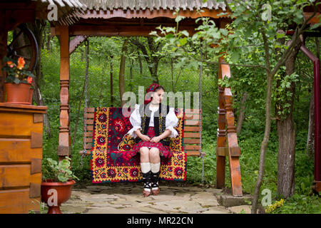 Portrait of a beautiful young woman wearing traditional Romanian clothes, in Maramures Stock Photo