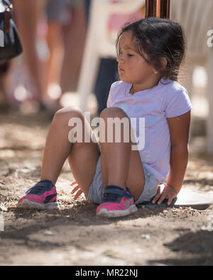A little girl at the annual Pow Wow gathering in Live Oak, California, resting for a while while festivities are going on. Stock Photo
