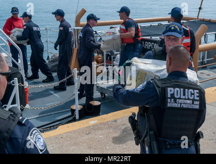 Crew members from Coast Guard Cutter Tarpon, an 87-foot Coast Patrol Boat homeported in St. Petersburg, Florida, offload 1,735 kilograms of cocaine, an estimated wholesale value of $56 million and transferred custody of eight suspected drug smugglers to partner federal agencies Wednesday, May 3, 2017 at Coast Guard Sector St. Petersburg, Florida. The contraband and suspected smugglers were interdicted during four separate cases supporting Operation Martillo, a joint interagency and multi-national collaborative effort among 14 Western Hemisphere and European nations to stop the flow of illicit  Stock Photo