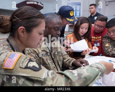 U.S. Army Capt. Maria Rodriguez and Master Sgt. Leroy Williams, both of the 25th Infantry Division Headquarters, confer with their Mongolian counterparts during Exercise Gobi Wolf 2017 May 2, 2017, in Dalanzadgad, Mongolia. GW 17 is hosted by the Mongolia National Emergency Management Agency and Mongolian Armed Forces as part of the United States Army Pacific's humanitarian assistance and disaster relief 'Pacific Resilience' series. (U.S. Army photo by Sgt. David Bedard) Stock Photo