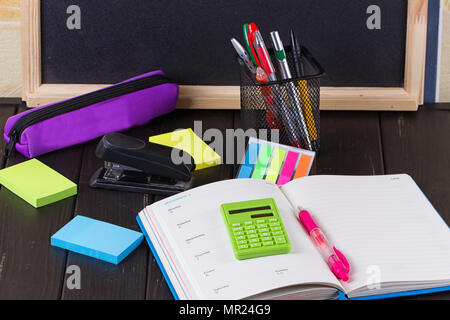 Open diary, pen on a black wooden background Stock Photo