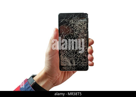 Hands holding broken mobile smartphone with broken screen isolated on white background. Cracked glass on a black telephone in the form of a web. Stock Photo