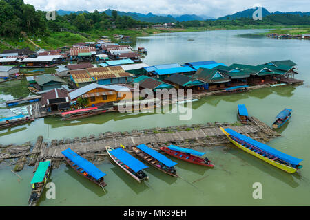 Rural village on river with wooden and bamboo port for travelling boat for tourists in Kanchanaburi, Thailand Stock Photo