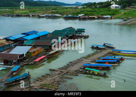 Rural village on river with wooden and bamboo port for travelling boat for tourists in Kanchanaburi, Thailand Stock Photo