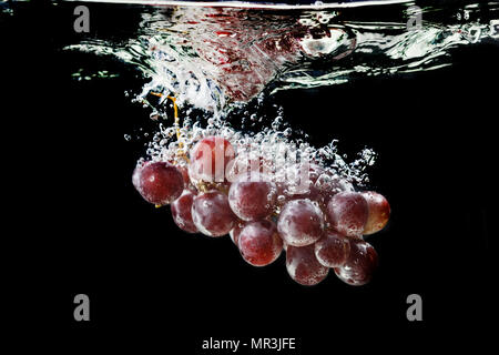 Red grapes with water splash Stock Photo