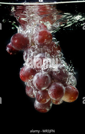 Red grapes with water splash Stock Photo