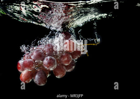 Red grapes with water splash Stock Photo