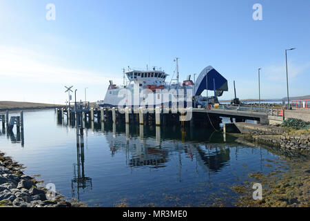 The Yell ferry that connects the mainland of Shetland to the island of Yell. Dropping off passengers and cars to the ferry terminal Stock Photo