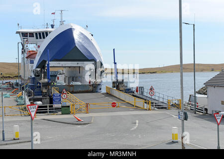 The Yell ferry that connects the mainland of Shetland to the island of Yell. Dropping off passengers and cars to the ferry terminal Stock Photo