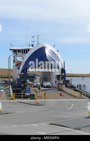 The Yell ferry that connects the mainland of Shetland to the island of Yell. Dropping off passengers and cars to the ferry terminal Stock Photo