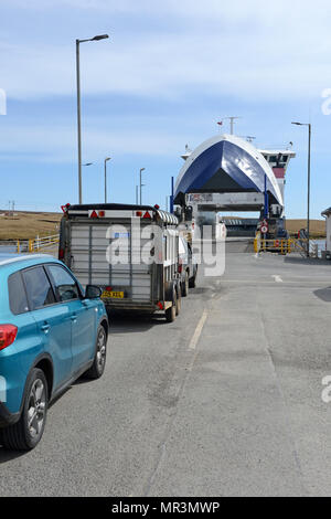 The Yell ferry that connects the mainland of Shetland to the island of Yell. Dropping off passengers and cars to the ferry terminal Stock Photo