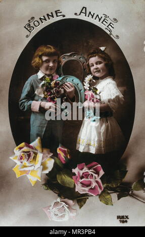 French Happy New Year, postcard depicting two small children circa 1900 Stock Photo