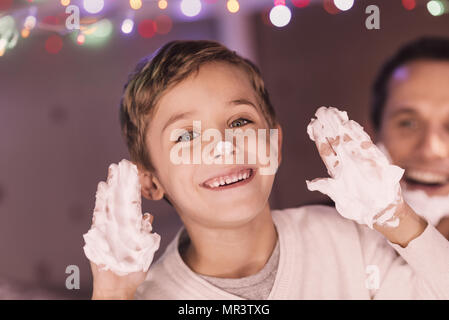 Delighted nice boy being in a playful mood Stock Photo