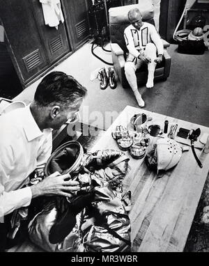 Photograph showing John Glenn's spacesuit being inspected. John Glenn (1921-2016) a United States Marine Corps aviator, engineer, astronaut and United States Senator. In 1962 he was the first American to orbit the Earth. Dated 20th century Stock Photo