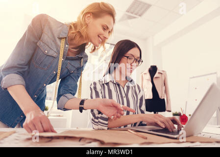 Cheerful tailors working in the studio Stock Photo