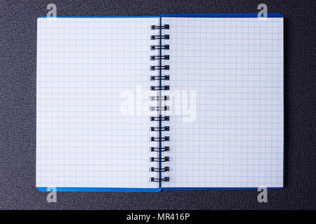 Open notepad on a spiral on a black background Stock Photo
