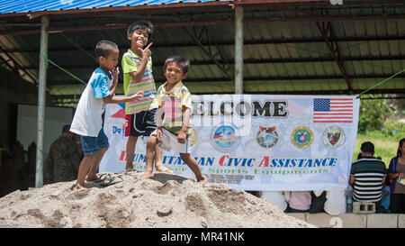 Filipino children pose for a photo at a disaster preparedness symposium during Balikatan 2017 in Ormoc City, Leyte, May 2, 2017. The Armed Forces of the Philippines along with representatives from Japan Self-Defense Force, Australian Defence Force, and U.S. military worked with a local barangay to improve health conditions and disaster preparedness. Balikatan is an annual U.S.-Philippine bilateral military exercise focused on a variety of missions, including humanitarian assistance and disaster relief, counterterrorism, and other combined military operations. (U.S. Navy photo by Mass Communica Stock Photo