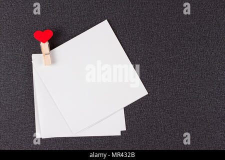 Template empty postcards with tiny clothespins on a red background. Stock  Photo